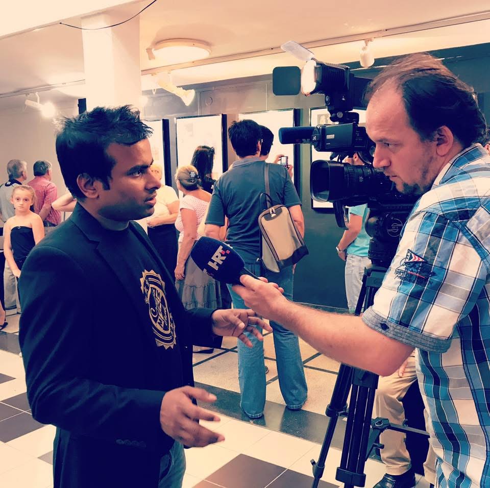 ARiF being interviewed for television at a cartoon exhibition
