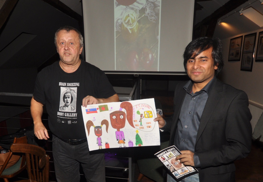 ARiF holding a children's artwork at the Women's Rights exhibition